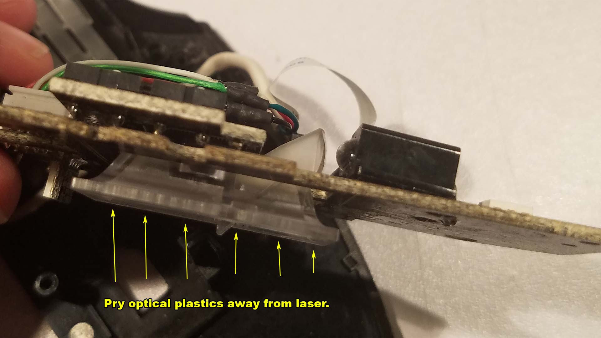 Remove optical plastics from laser assembly.