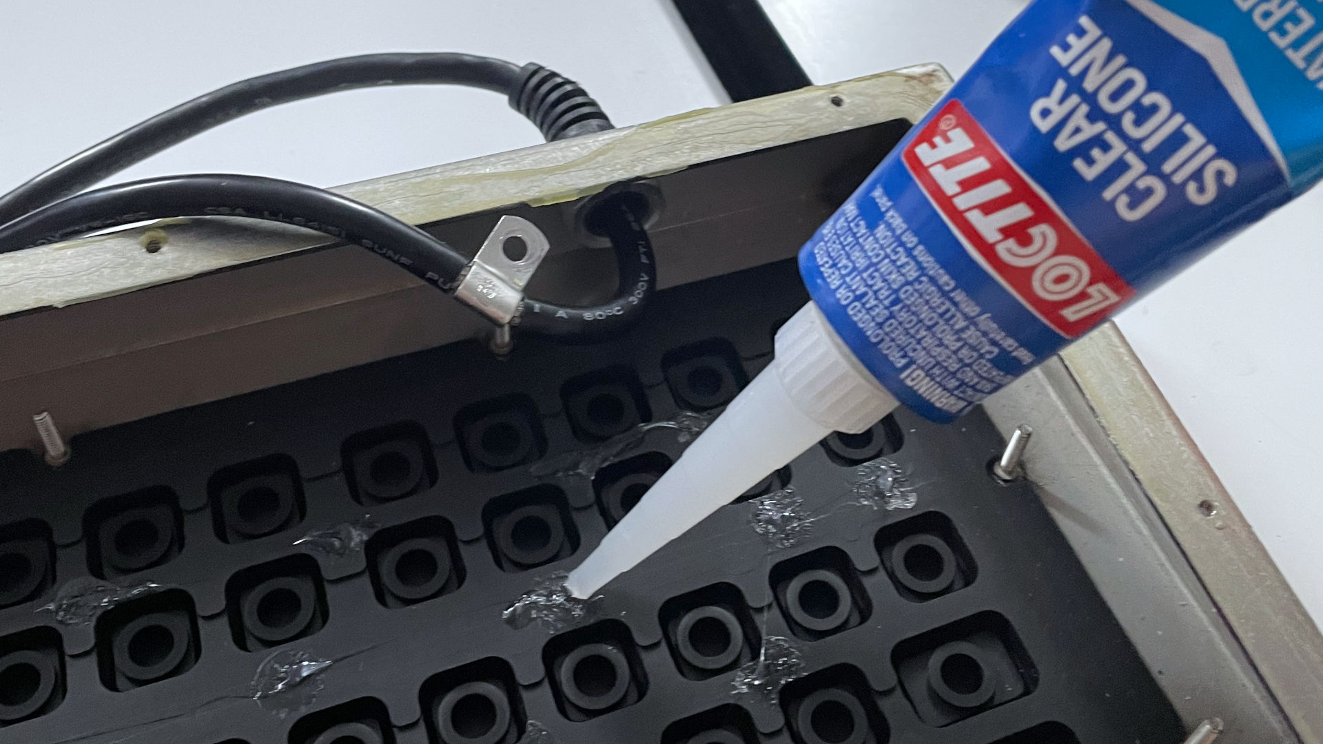 Industrial Computer Source KB5HP - applying silicon glue.